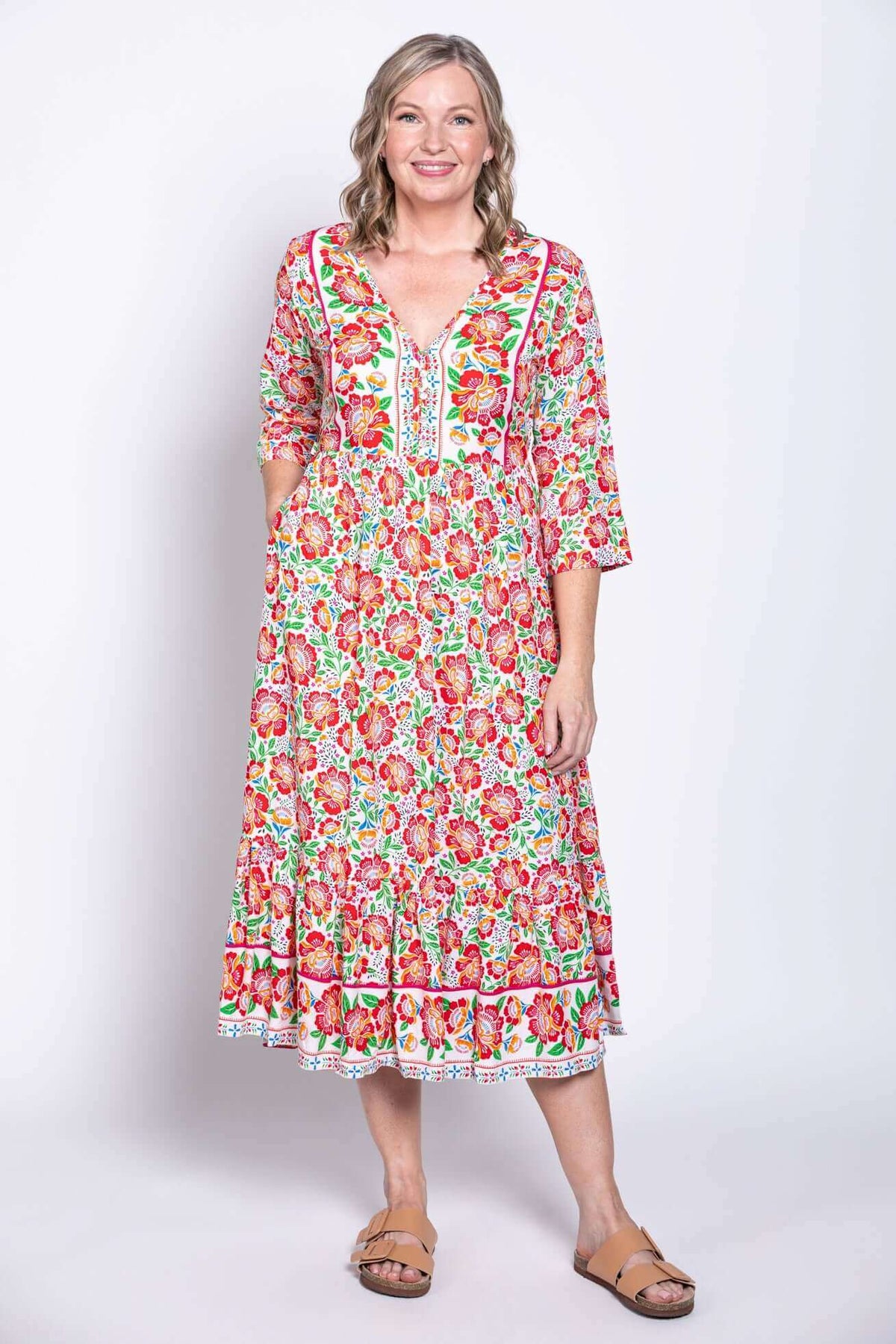 Model standing in floral batik midi dress viewed from front