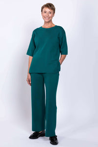 Front view of model wearing teal short-sleeve sweater and pants set