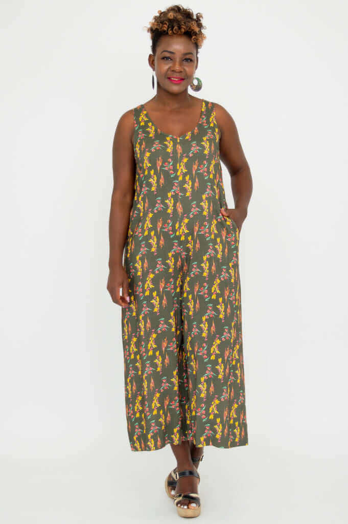 Woman modeling a floral bamboo linen sleeveless jumpsuit, hands in pockets, full-length