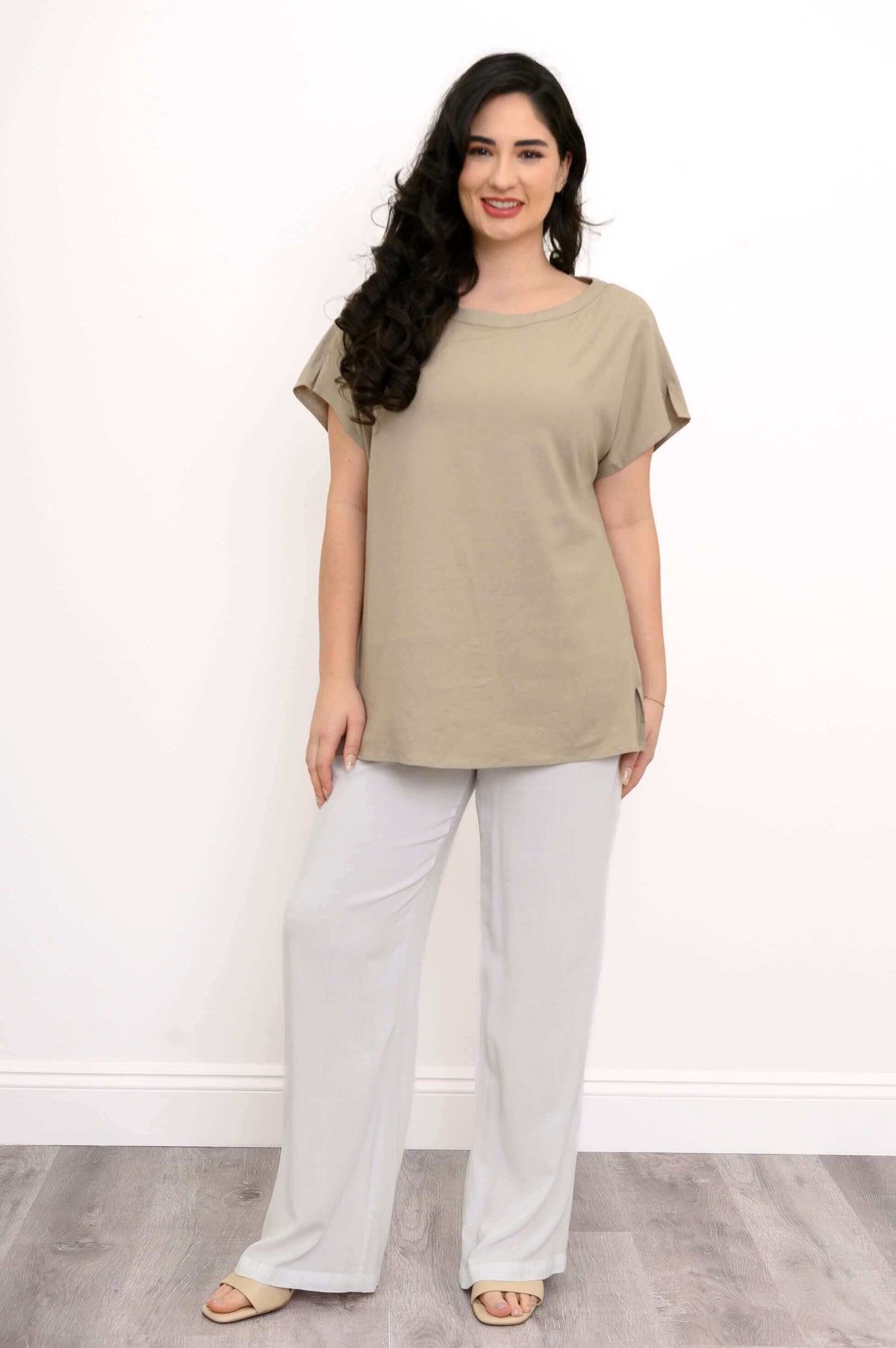 Full-length front view of woman wearing beige linen blend tee