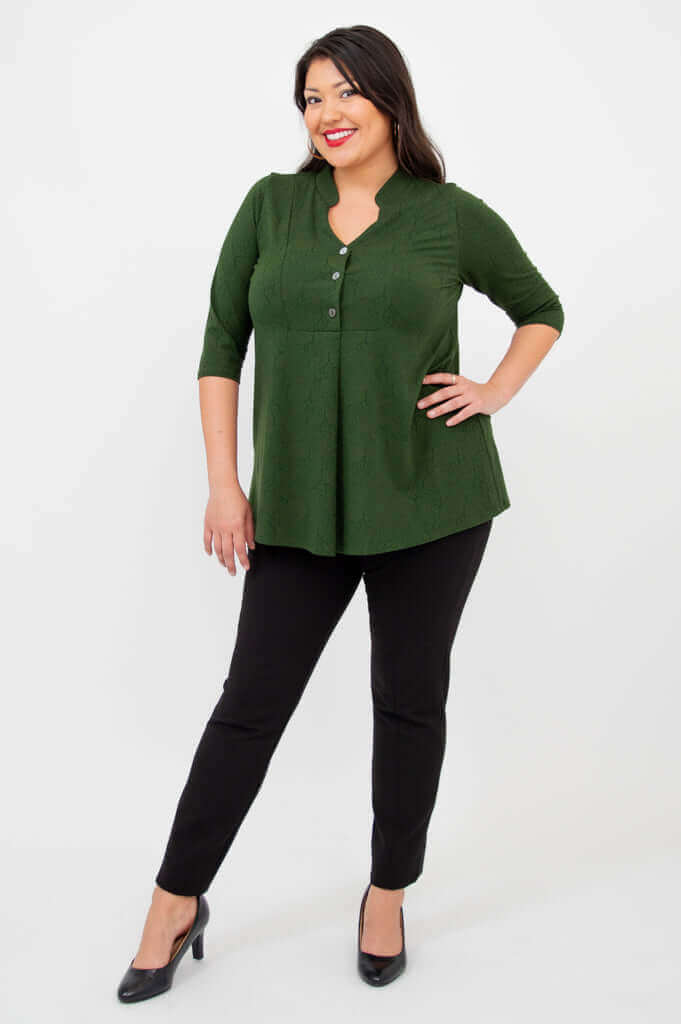 Full-length view of a woman in green 3/4 sleeve bamboo top and black pants