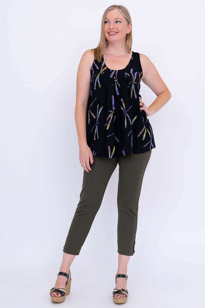 Full-length view of woman modeling black dragonfly print pleated tank top and olive pants