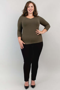 Full-length shot of model in olive bamboo top and black pants