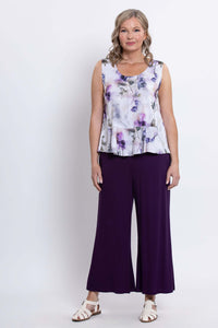 Woman shown full-length wearing a sleeveless purple floral top and matching purple wide-leg pants