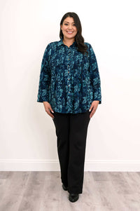 Full view of model in blue floral smocked shirt and black pants