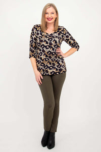 Full body view of woman in leopard print long sleeve top and olive pants