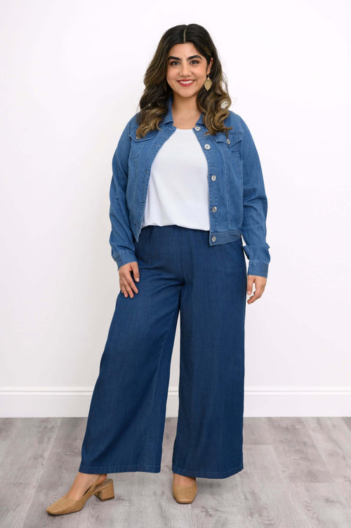 Full body shot of a woman modeling a blue Tencel denim jacket with matching wide-leg pants.
