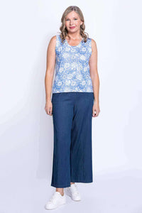 Full body front view of woman in blue floral tank and wide leg blue pants