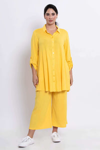 Full body front view of model in sunflower yellow tunic and matching wide-leg pants