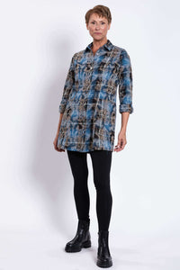 Full body front angled view of woman modeling blue plaid flannel tunic with black leggings