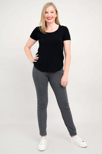 Full body front pose in black scoop neck tee and grey pants with sneakers