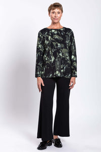 Full body front view of a woman modeling a relaxed bamboo print top with black pants