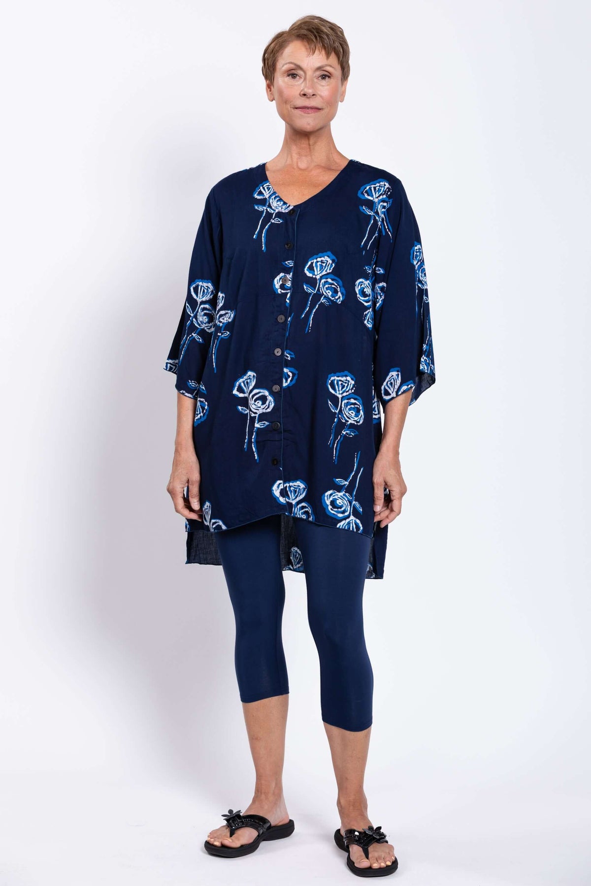 Full front view of woman modeling navy blue Darla blouse and navy capri leggings