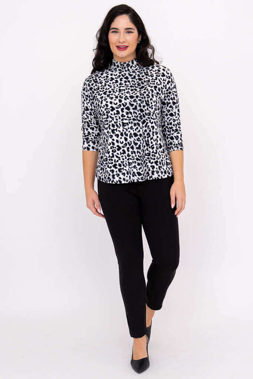 Full body front view of model in animal print Highdrop Top and black pants