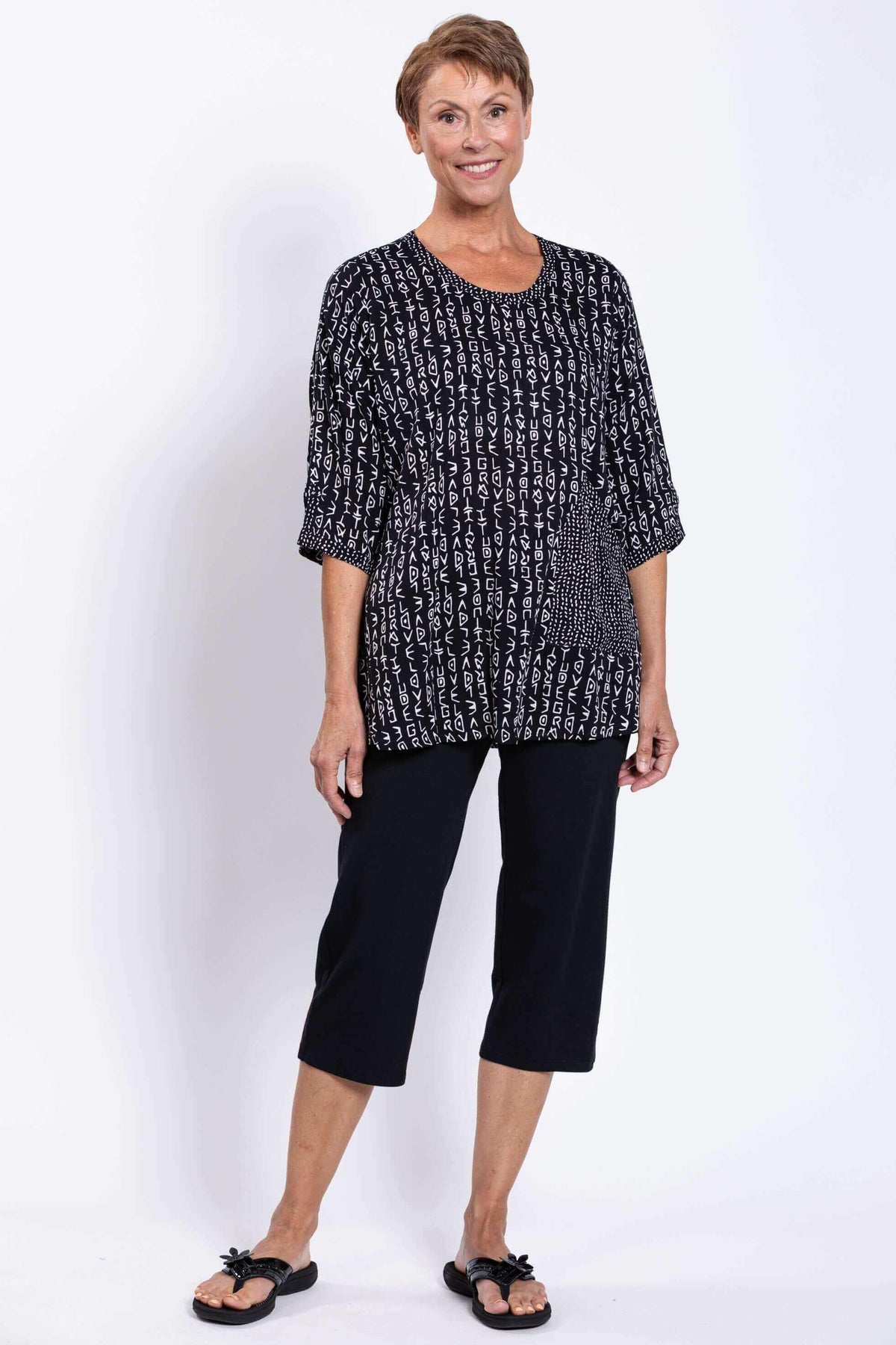Full body front view of woman in Palace Blouse black abstract print with black pants