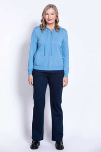 Full body front view of woman in blue hoodie and navy pants