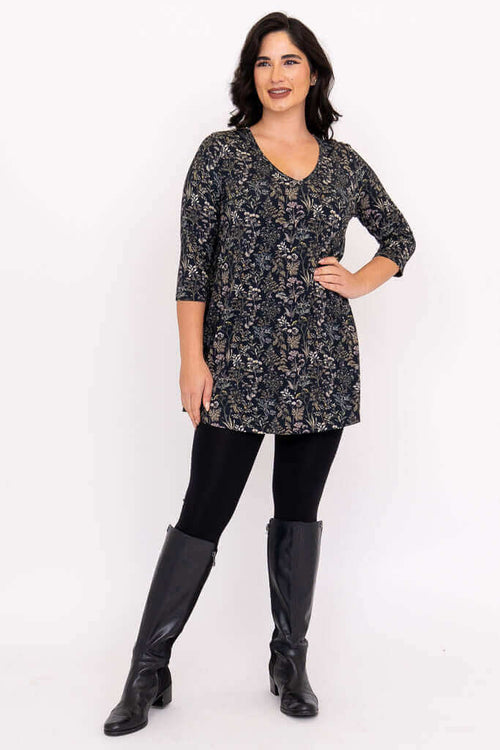 Full body front view of model in floral bamboo tunic, leggings, and boots