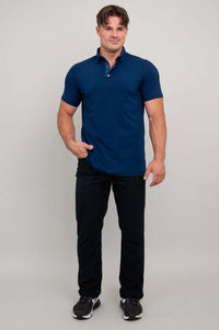 Man in navy polo shirt and black pants, standing casually, full body front view