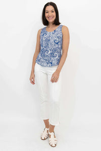 Full body front view of woman modeling Dee Tank blue swirl print top and white pants