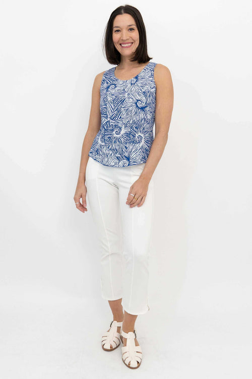 Full body front view of woman modeling Dee Tank blue swirl print top and white pants