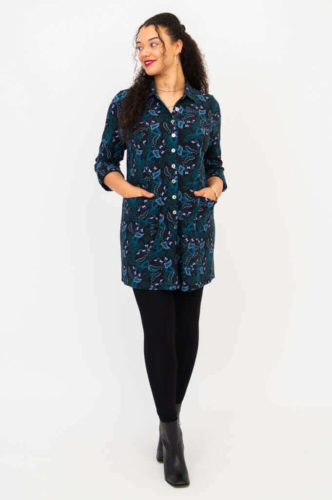 Full body front view of model in patterned bamboo tunic shirt paired with leggings and boots