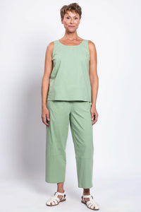 Full body front view of model in sage green tank top and pants with white sandals