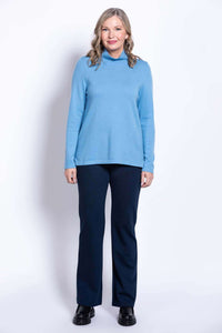 Full body front view of woman in light blue cashmere blend sweater