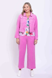 Full front view of woman in pink corduroy jacket and pants with floral shirt
