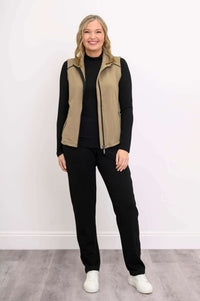 Full body front view of woman wearing tan Hartford Utility Vest and black pants