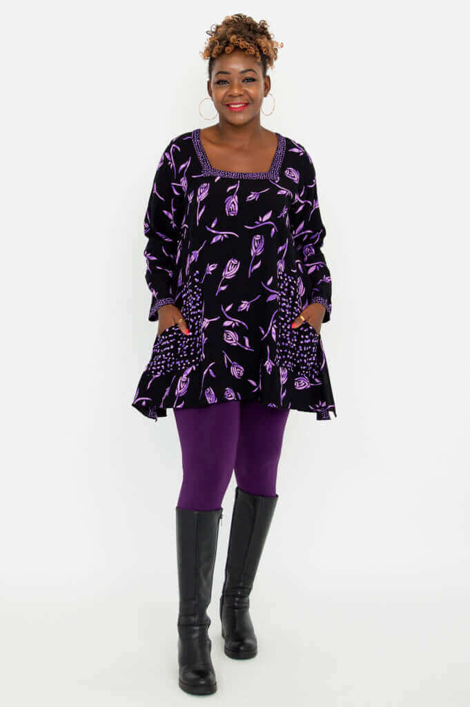 Full body view of Maria Tunic paired with purple leggings and black boots
