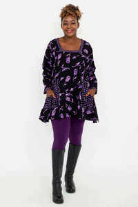 Full body view of Maria Tunic paired with purple leggings and black boots
