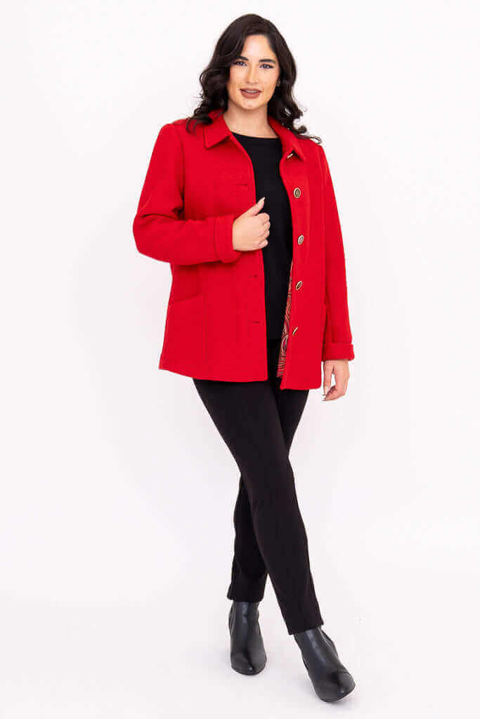 Full body view of woman modeling a red wool coat with the front open