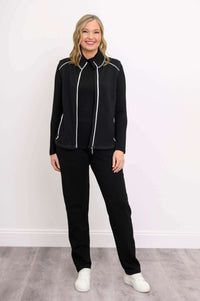 Full body shot of woman modeling black Hartford Utility Vest with pants and white sneakers