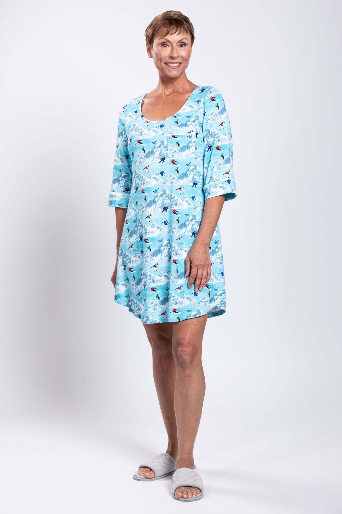 Full body view of woman in blue skier-pattern bamboo sleepshirt with 3/4 sleeves