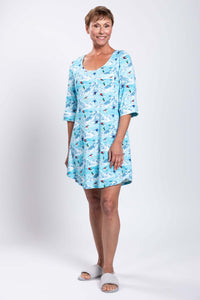 Full body view of woman in blue skier-pattern bamboo sleepshirt with 3/4 sleeves