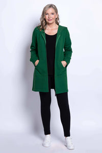 Full body view of a woman in a green hooded jacket with zip front and black leggings