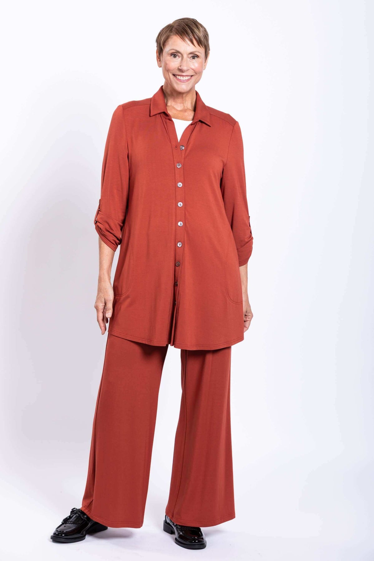 Full body view of model in rust bamboo blouse and matching wide leg pants