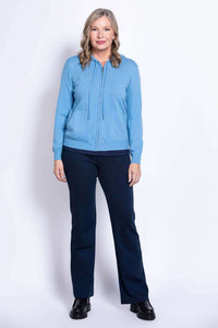 Straight-on full body view of woman in blue zip hoodie and navy pants