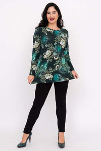 Full body view of a woman wearing a floral long sleeve tunic top and black pants