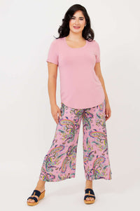 Full body view of model in light pink Tessa Tee and paisley wide-leg pants