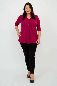 Full body front view of woman in raspberry V-neck bamboo top with black pants and heels