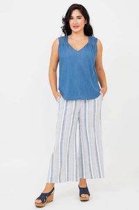 Full body front view of woman wearing blue Tencel tank and wide-leg striped pants