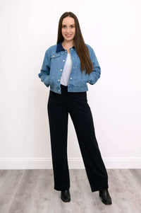 Full body view of a woman in The Gerry jean jacket with hands in pockets