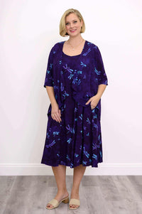 Full body view of woman in matching purple dragonfly print Toucan Jacket and dress