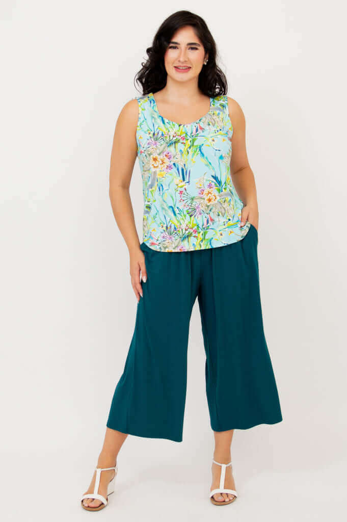 Model standing, hands in pockets, wearing Ritzy Tank and teal wide-leg pants