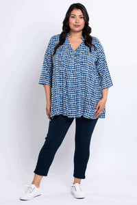 Full body view of model in blue batik Shirley blouse and navy pants