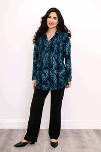 Full body view of model in blue patterned tunic and black pants