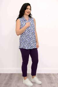 Full body view of model wearing The Hula sleeveless tank top with purple pants