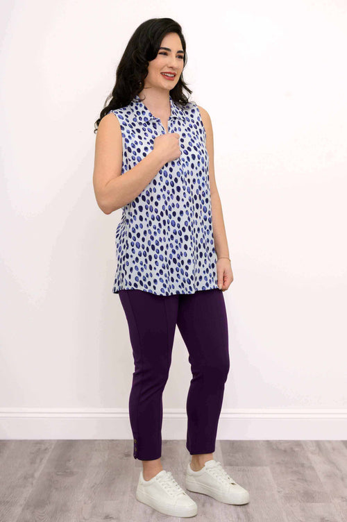 Full body view of model wearing The Hula sleeveless tank top with purple pants