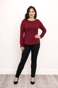 Full body view of woman in maroon boat neck top and black pants